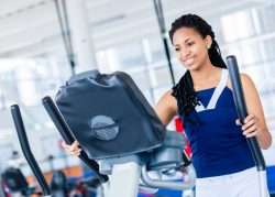 Woman working on Elliptical Machine