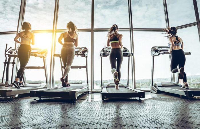 two females running on a treadmill