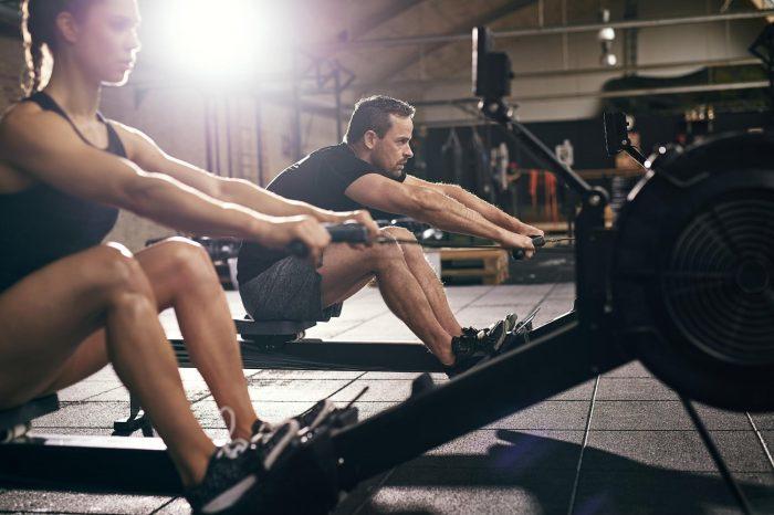 male and female on an indoor rowing machine